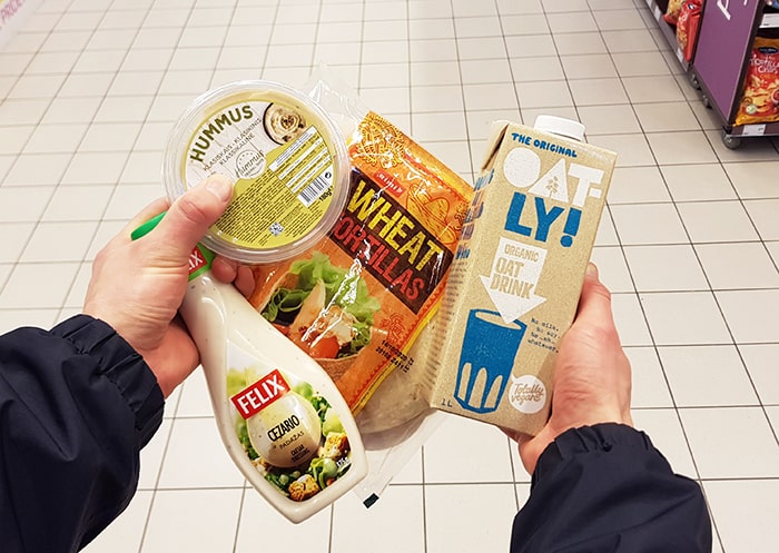 Hands holding processed food that can be made at home.